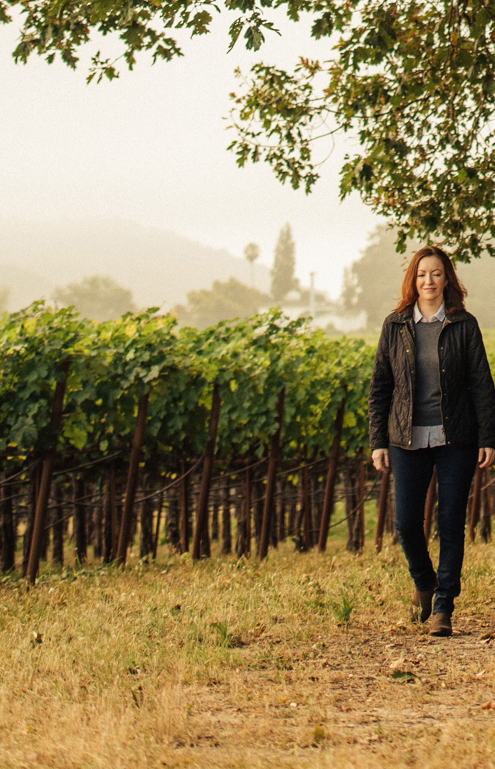 Kristy Melton walking in a vineyard