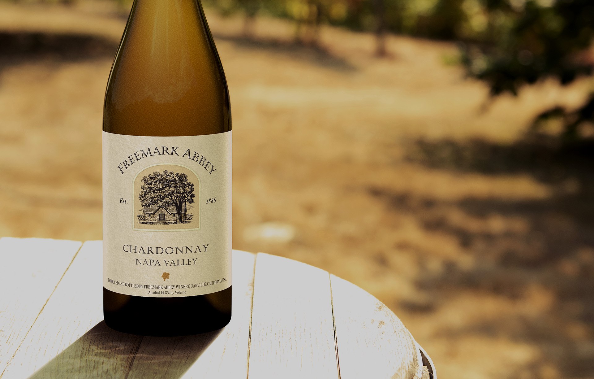 A bottle of Freemark Abbey Chardonnay on a table outside