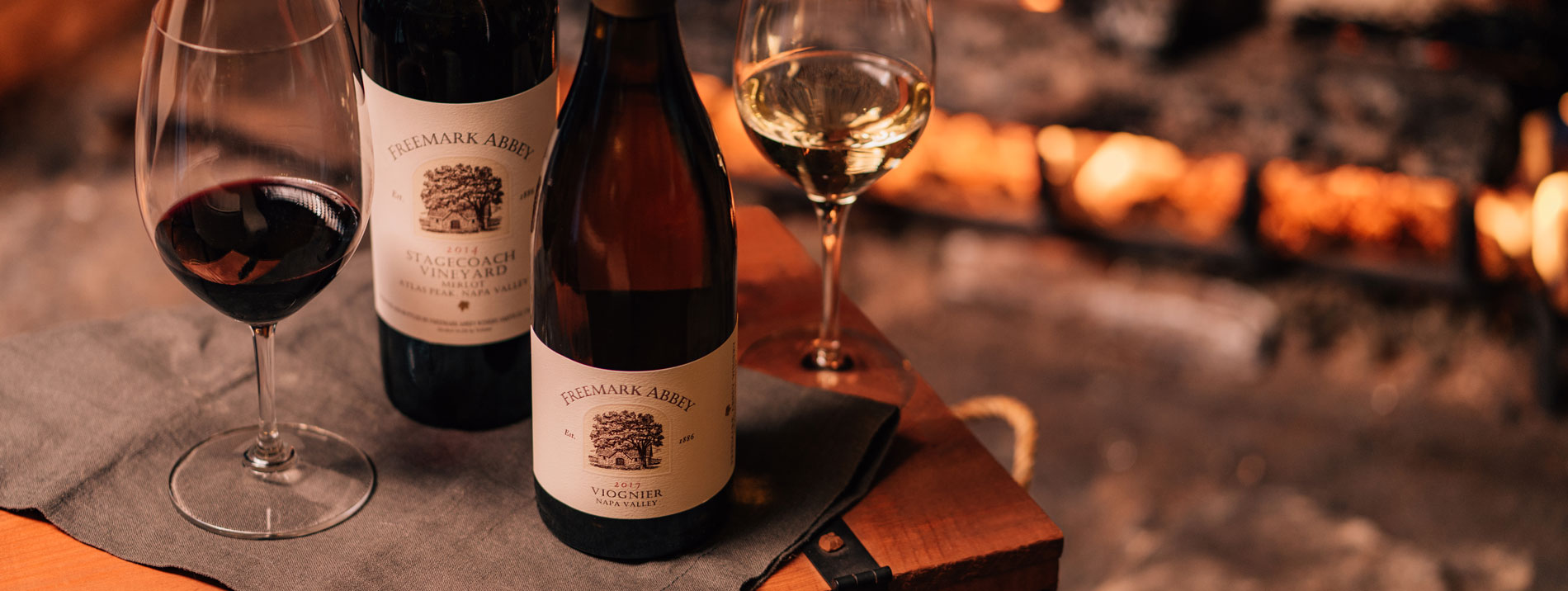 A selection of Freemark Abbey wine by a fireplace